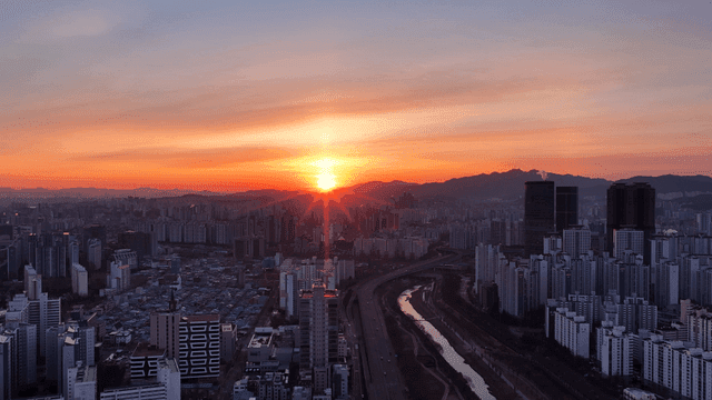 Sunset over a sprawling city skyline