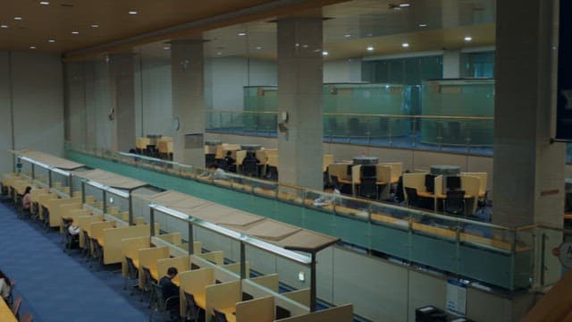 Students studying in a modern library's study cubicles