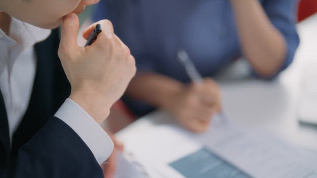 People discussing documents at a table