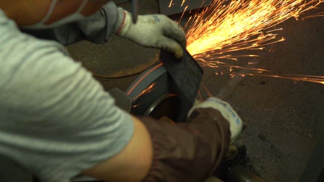 Worker sharpening a knife in a workshop