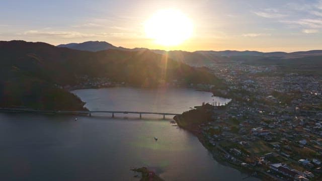 다리가 있는 호수 위로 떠오르는 해