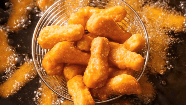 Golden nuggets being fried in hot oil