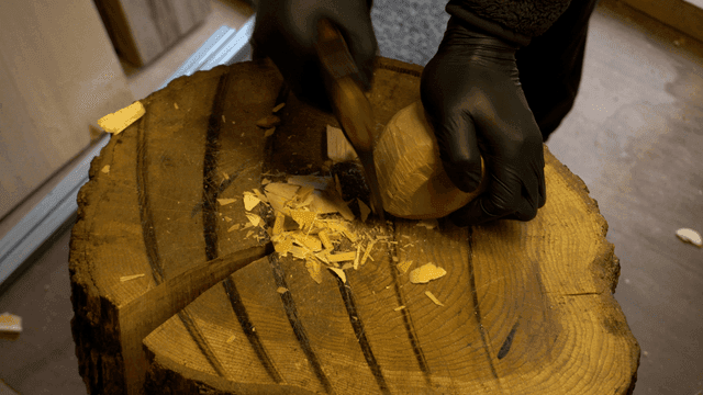 Wood carving on a tree stump indoors