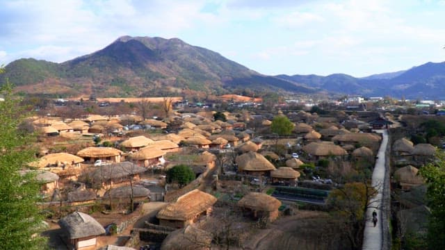 Rural village with thatched-roof houses in the mountains