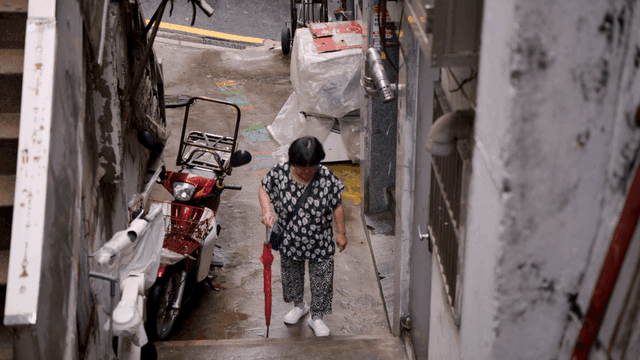 A woman walking in a narrow alley