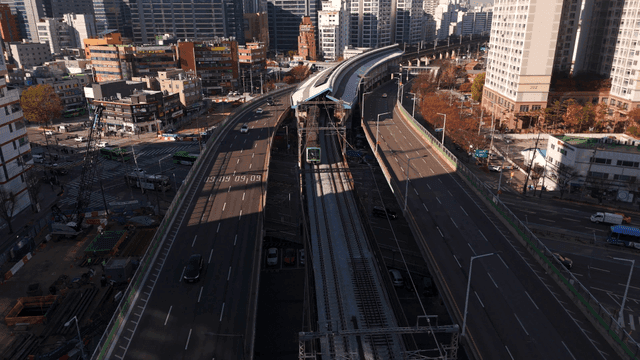 Aerial view of city with roads and trains