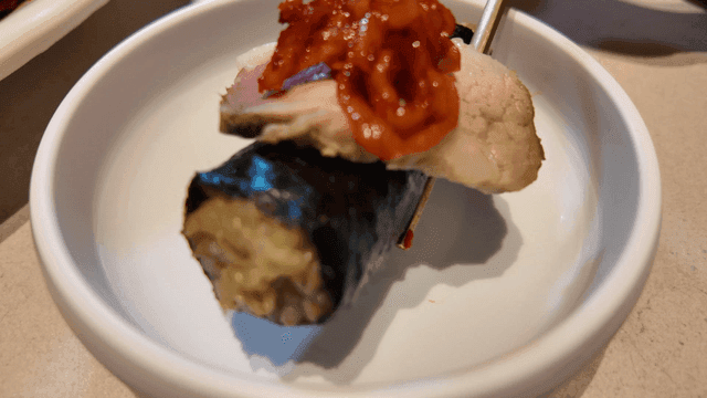 Kimbap with boiled pork and kimchi in a bowl