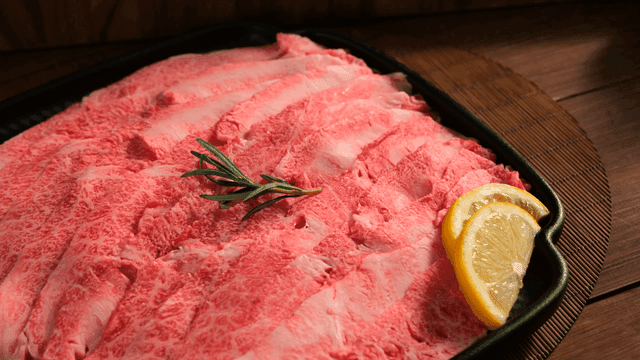 Freshly sliced marbled beef with lemon