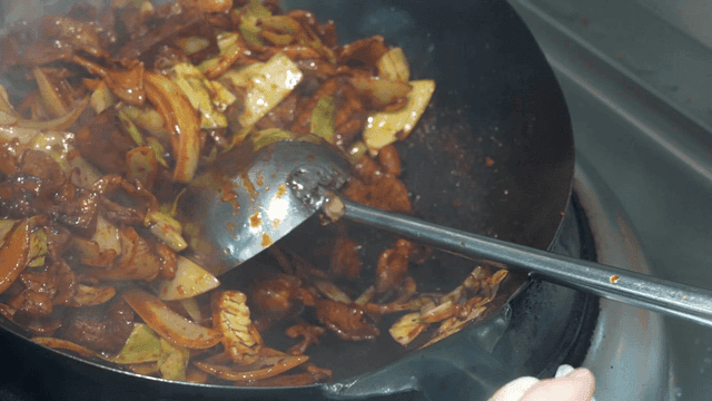 Jeyuk-bokkeum, where vegetables and meat are stir-fried in wok