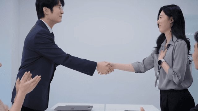 A meeting scene where the signed contract is handed over