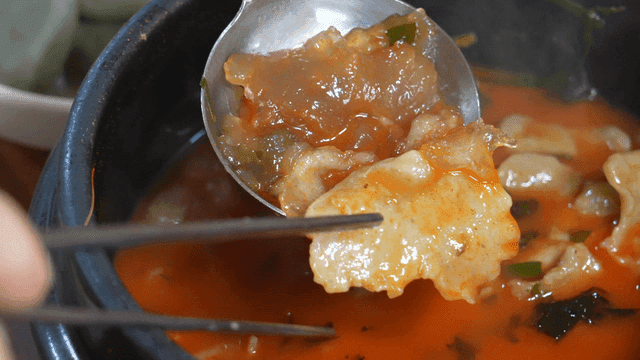 Two spicy handmade dumplings made differently on spoon