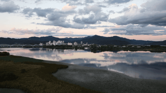 City skyline with mountains and river