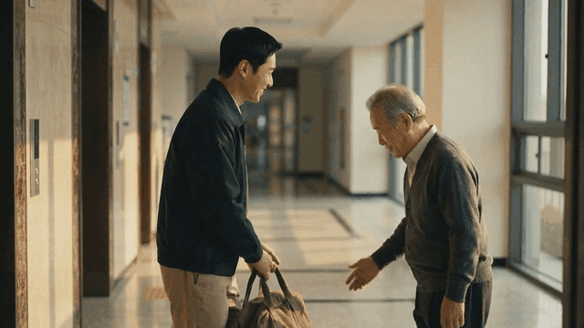 Elderly man and young man having friendly conversation in hallway