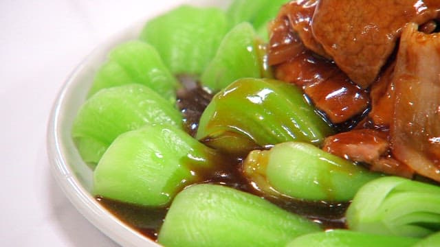 Plate of spice pork with bok choy