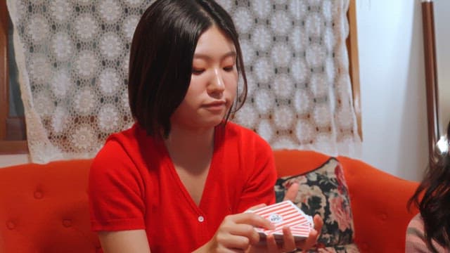 Two friends playing cards indoors