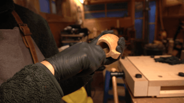 Craftsman carving wood in a cozy workshop
