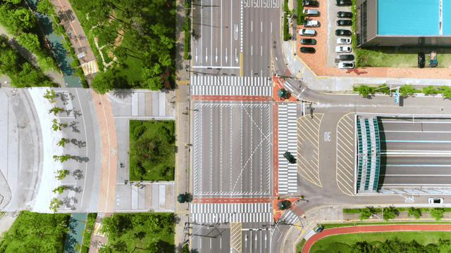 Aerial view of a city road with greenery
