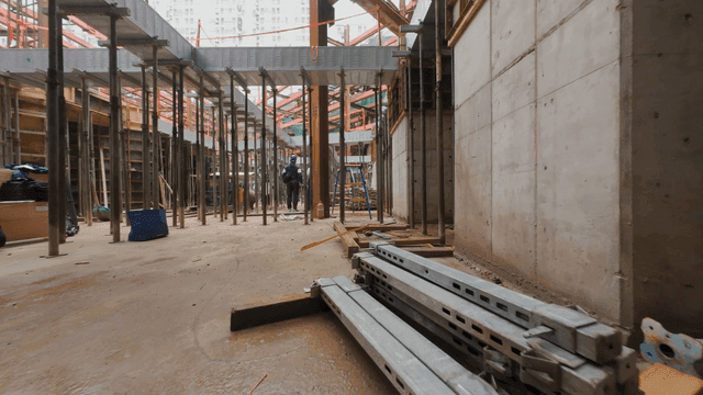 construction site with metal beams and workers