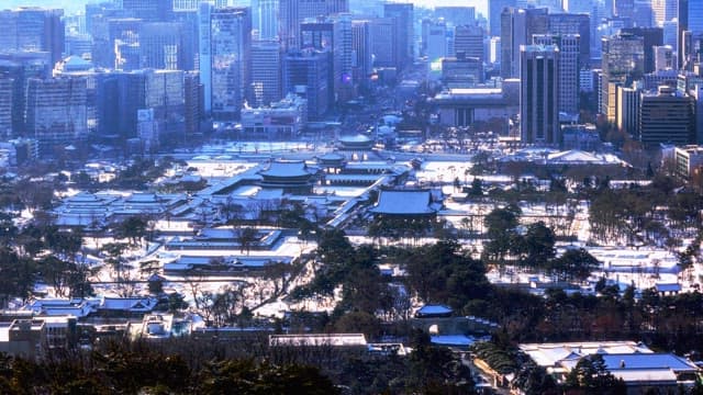 Historic palace surrounded by snowy urban landscape