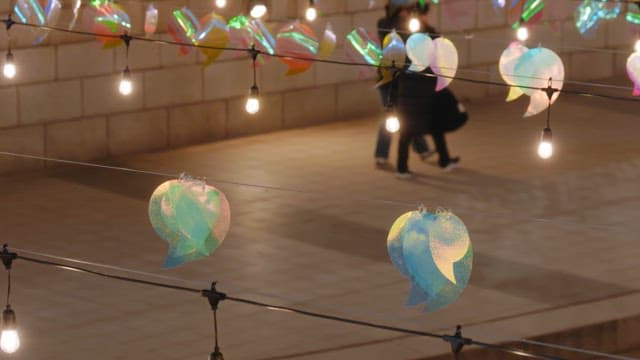 People enjoying the colorful lanterns that light up cheonggyecheon stream