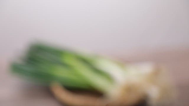 Fresh green onions on a woven basket