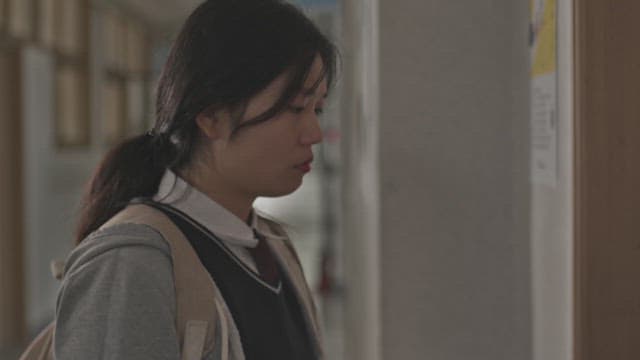 Female student turns back after waiting in front of the door