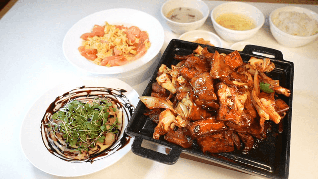 Spicy stir-fried pork and cream shrimp on table