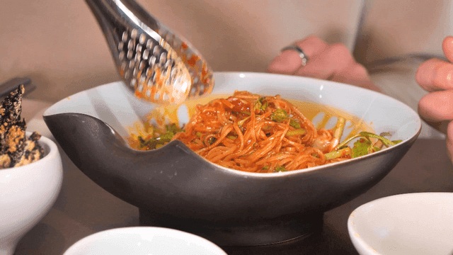Tongs for mixing spicy bibim noodles in bowl