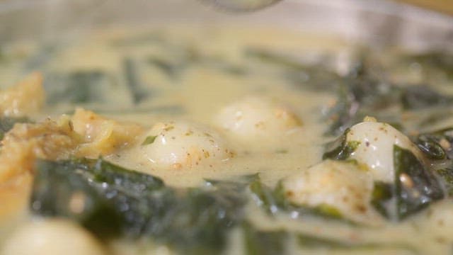 Spoonful of warm glutinous rice dumplings with dried pollack and seaweed