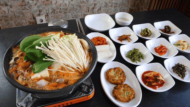 Table set with Korean side dishes and stew