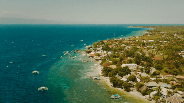 Coastal village with boats and clear sea