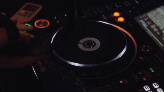 DJ mixing music in a dark space
