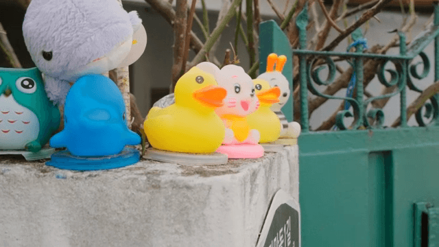 Colorful toys on a concrete ledge