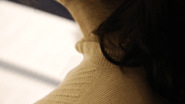 Back view of woman writing in notebook