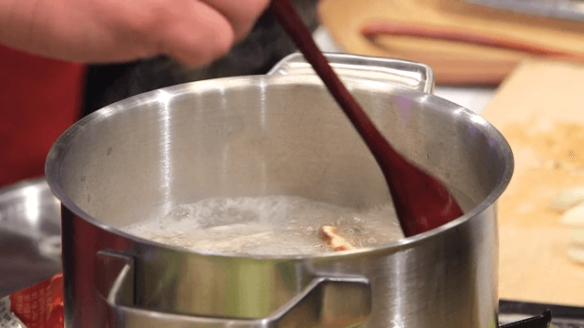 Stirring ingredients in a boiling pot