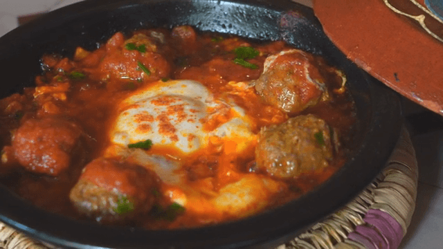 A dish of shakshuka with meatballs