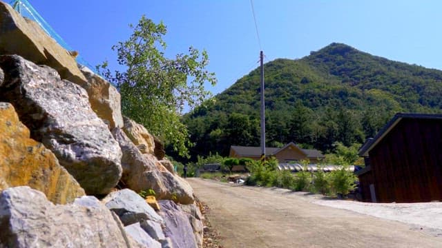 Rural stone road on a sunny day with mountains in the background