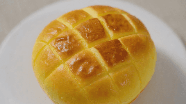 Freshly baked round melon bread on plate