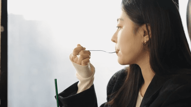 Woman enjoying a coffee and cake at a cafe