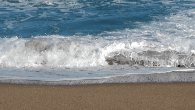 Waves coming onto sandy beach