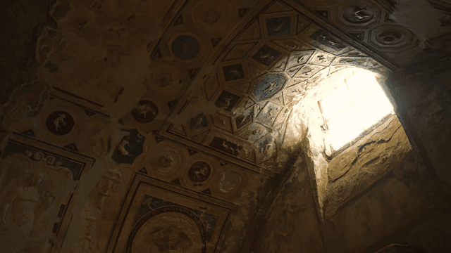Ancient frescoes on a dimly lit ceiling
