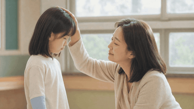 Young girl comforted by looking at woman