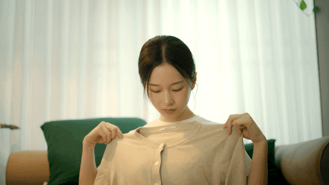 Woman wearing beige cardigan in living room