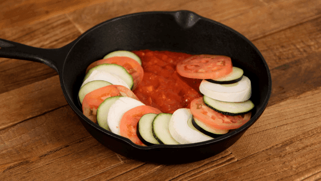 Ratatouille with vegetables arranged in frying pan