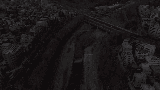 Cityscape with river and bridge.