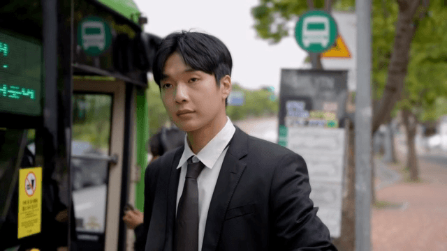 Anxious office worker waiting for a bus at a bus stop