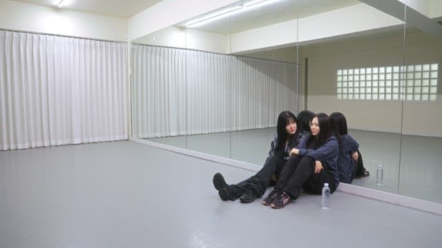 Young women resting in a dance studio