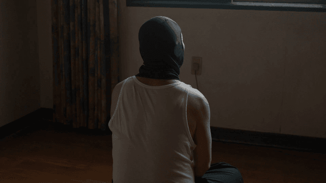 Back view of masked man