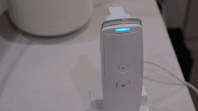 White device with a blue light indicator