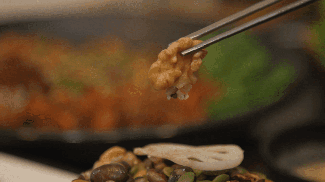 Dried walnuts picked up with chopsticks